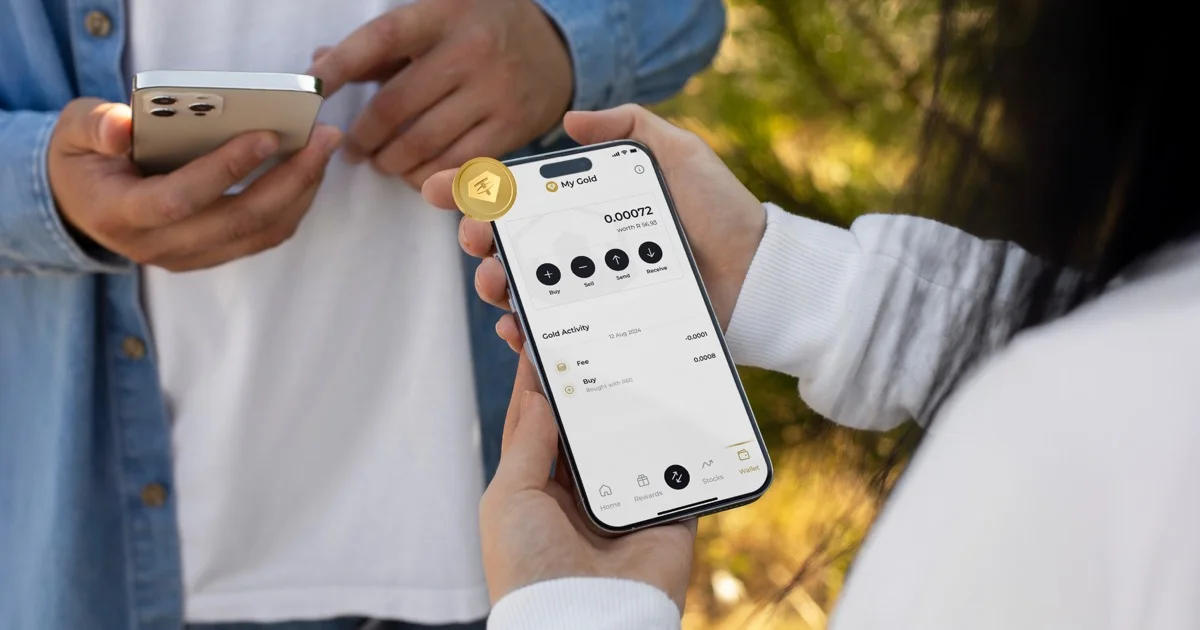 Hands holding smartphone showing Kastelo Gold Wallet app and gold coin
